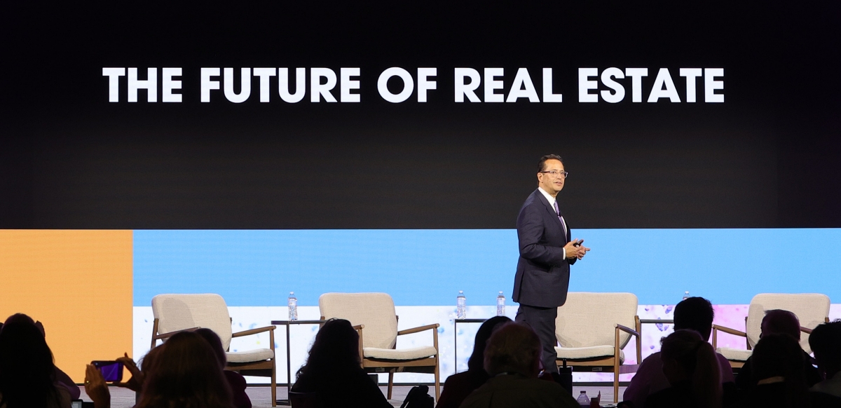 Alex Lange onstage at an iOi Summit Event, new era of real estate